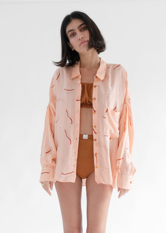 Girl wearing pink silk printed shirt and brown underwear set